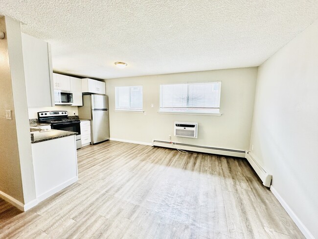 Experience the charm of this bright, open-concept kitchen and living space, perfect for entertaining. - Hawk Point Apartments