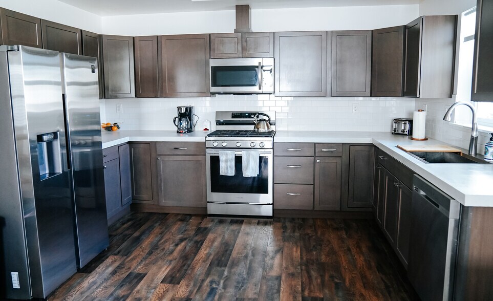 modern kitchen with brand new appliances - 525 8th Ave W
