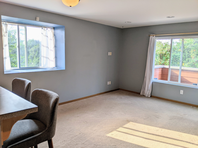 Living room with large windows with views of trees - 4810 S Holly St