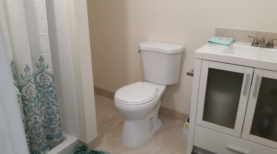 Full bathroom, shower, sink, toilet, storage shelves - 307 Tramore Ct