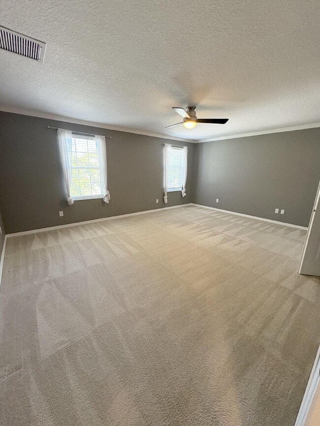 Building Photo - Spacious 5-Bedroom Pool Home with Putting ...