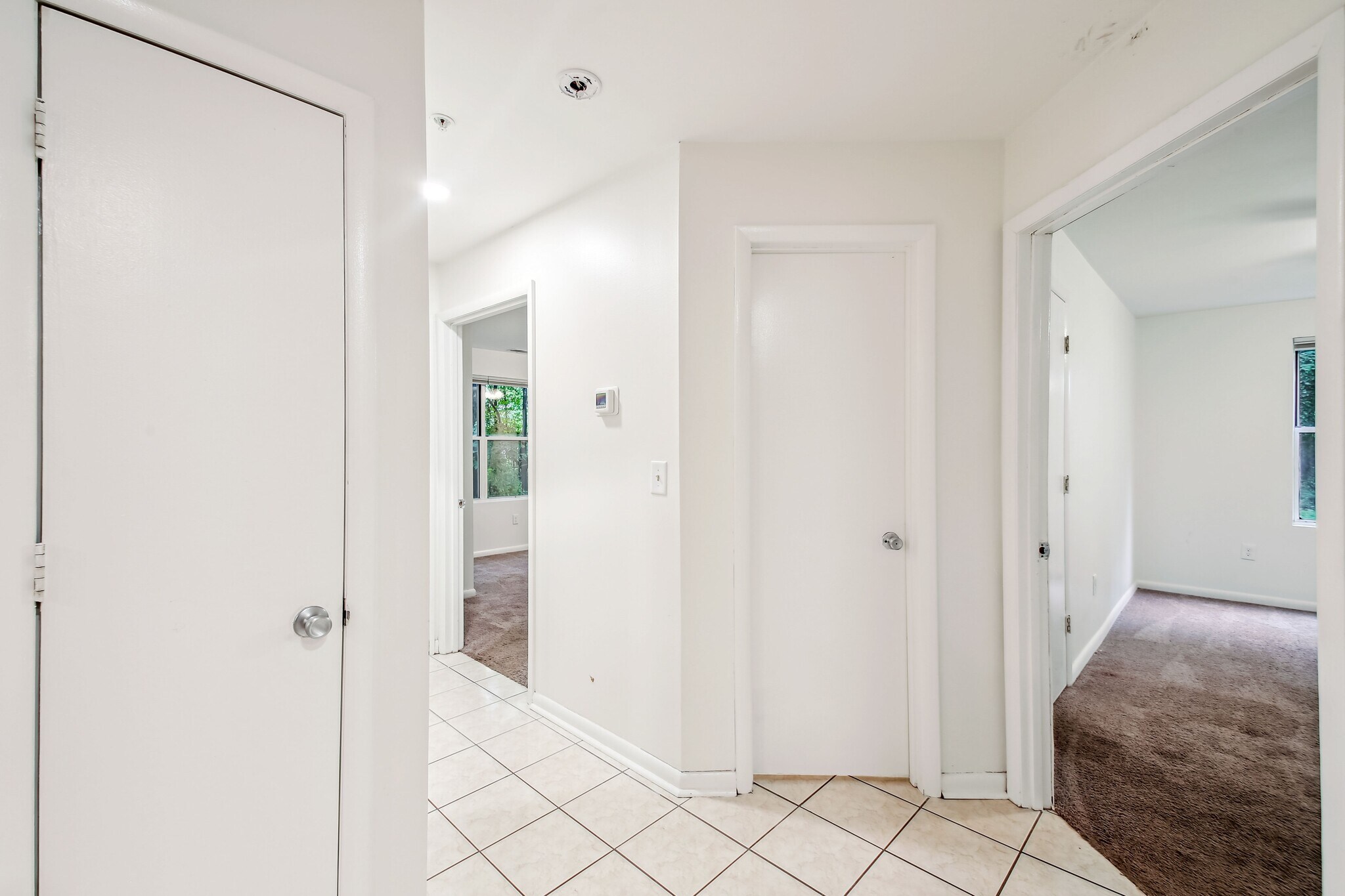 Looking at Main Bathroom Door Closed to Right is Second Bedroom Door Open and on Left is Master Bed - 30 Hearthstone Ct