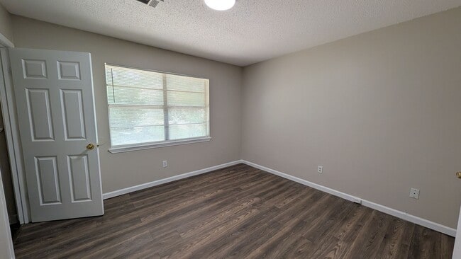 Building Photo - Fenced Yard, Lots of Light, Hard Floors Throughout