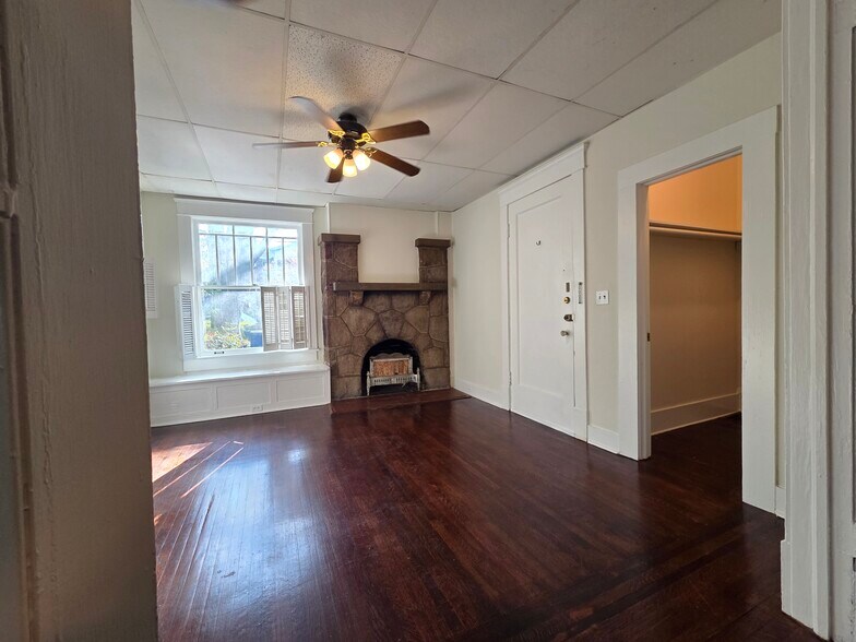 Living Room with bench seating, mantle, and view of walk in closet - 974 N Highland Ave NE