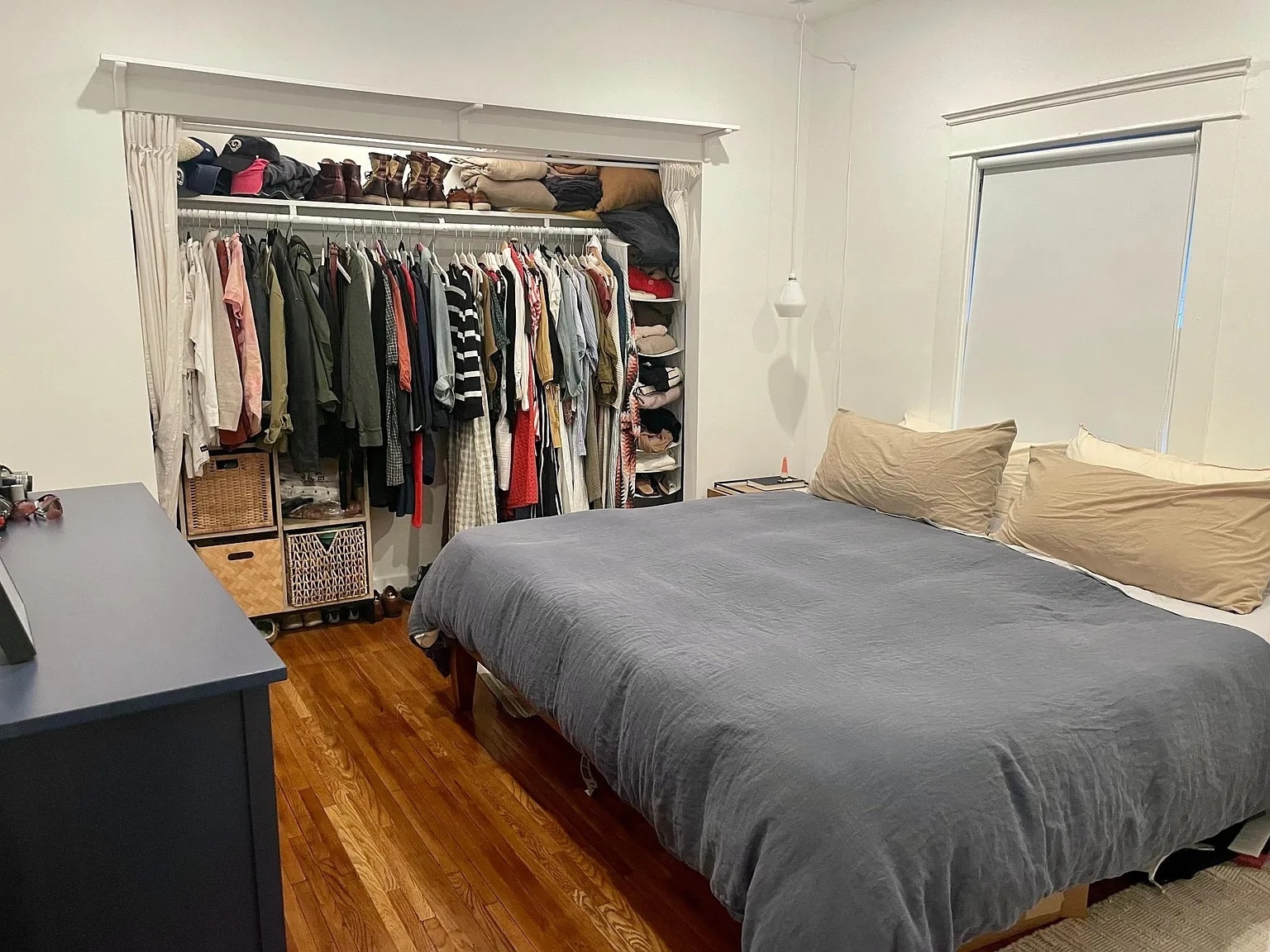 Primary bedroom with a wide open closet and hardwood floors. - 6000 Carlton Way