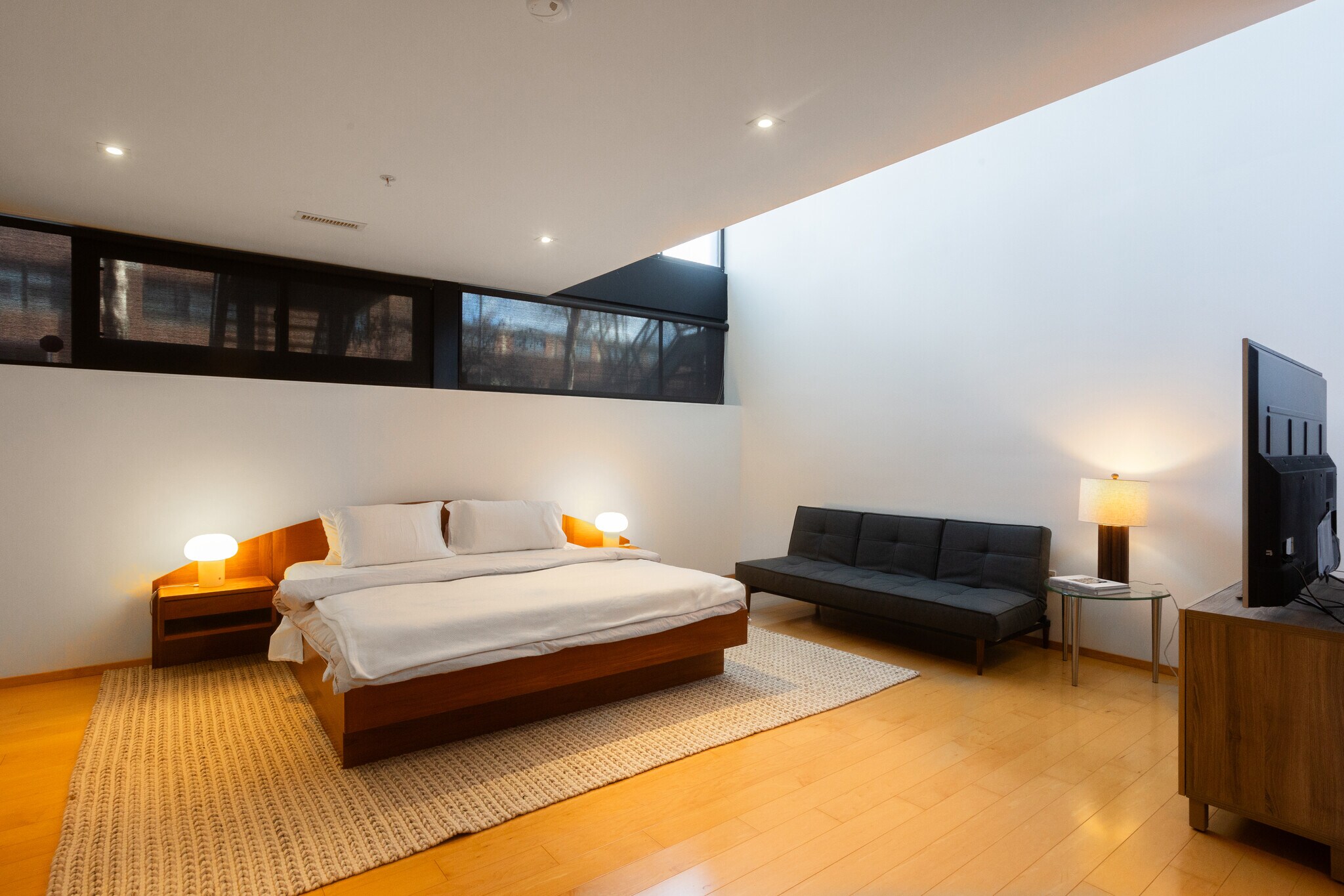 Primary bedroom with shades rolled down and lit. - 2250 11th St NW