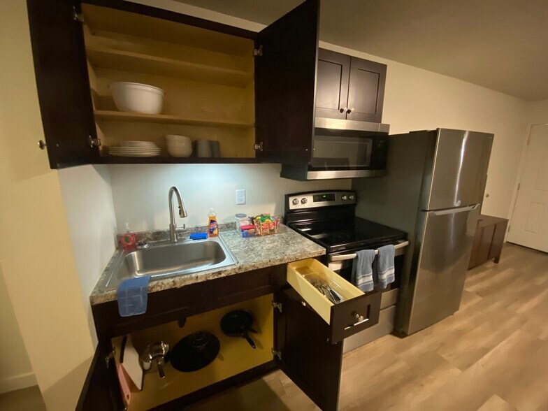 Equipped with essential kitchen, tools, silverware, cups, and plates - 570 W Main St