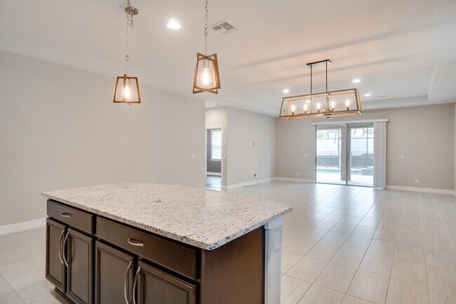 Building Photo - Stunning 3-Bedroom Pool Home with Bonus Room in the Gated Community of Lakeshore at Narcoossee
