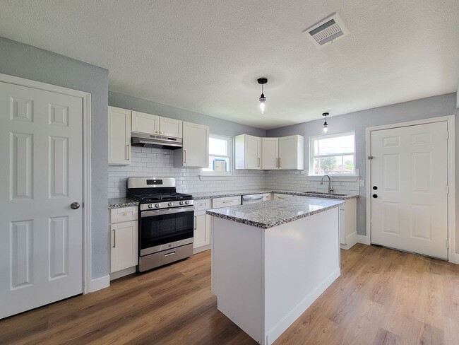 Building Photo - This beautifully updated 4-bedroom home is just under two miles from Highway 288 and Loop 610, ma...