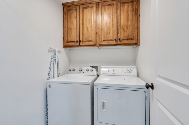 Laundry room with built-in linen cupboards - 10441 S Sage Vista Way