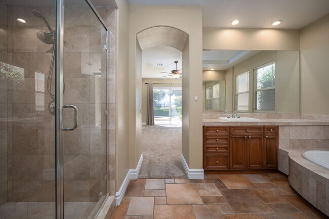 Large double vanity with spa tub and separate walk-in shower in the primary bath - 2850 Bronzino Ct