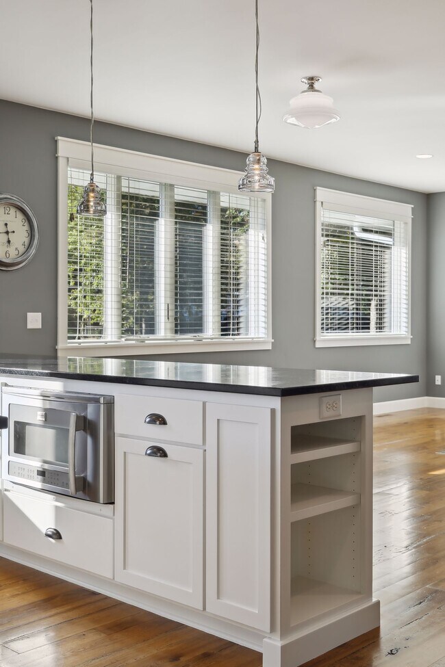 12' long Soapstone counter overhang for barstools and rollout trash & recycling center. - 924 Eleanor Ave