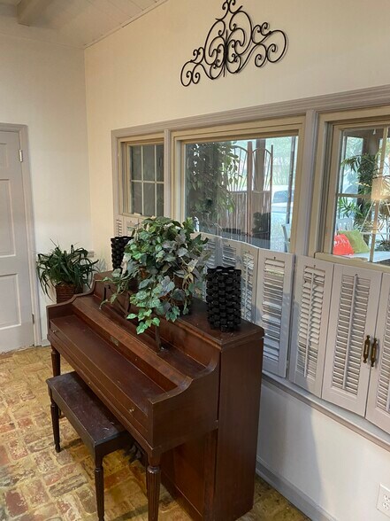 A quiet corner where brick walls and piano melodies create pure comfort. - 5460 Scofield Rd