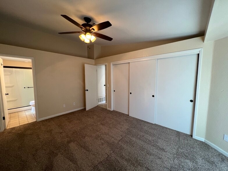 Primary Bedroom with Sliding Door Access to back patio - 212 Oak Meadow Ln