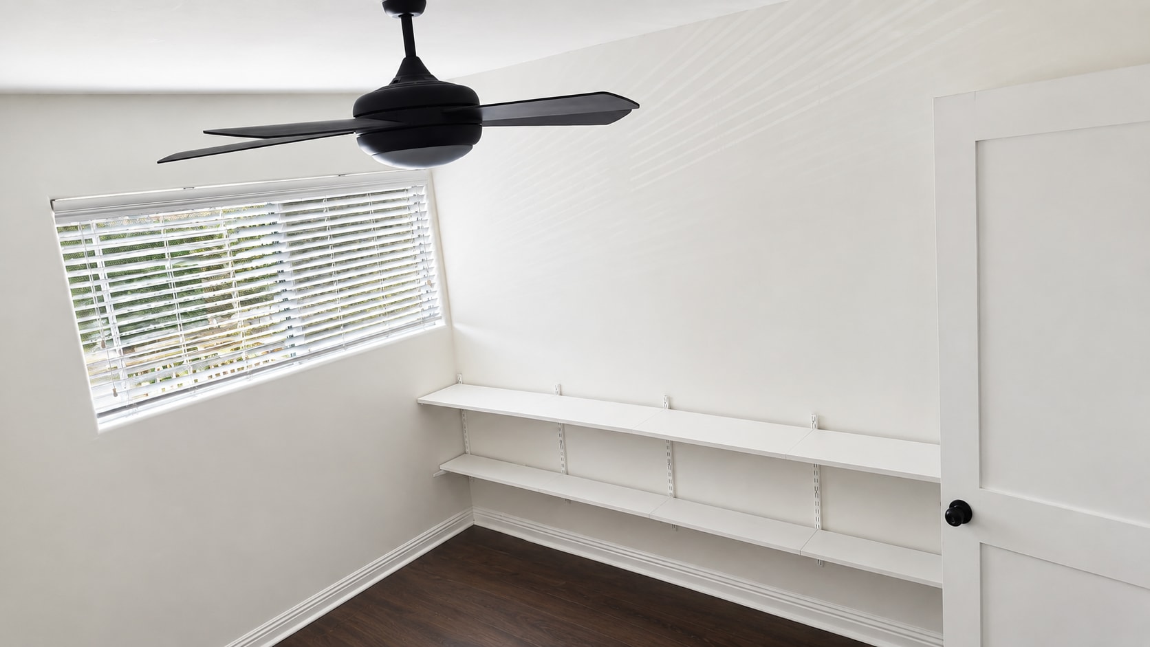 Guest Bedroom: Bright guest room with custom shelving. - 6191 Rancho Mission Rd