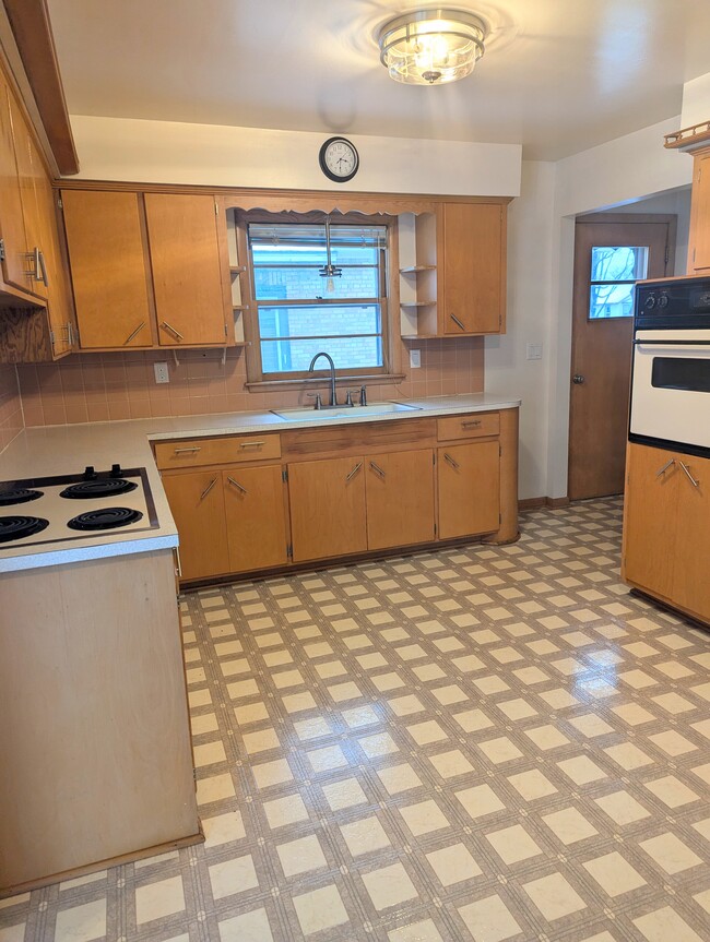 Kitchen features updated lighting and fixtures with low maintenance and easy clean vinyl flooring. - 910 Maple St