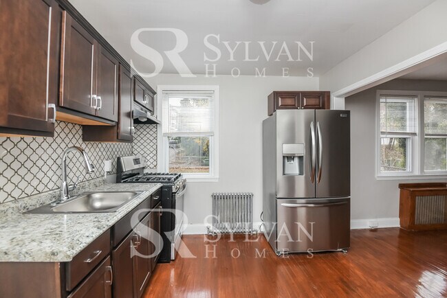 Building Photo - Welcome to this charming abode.