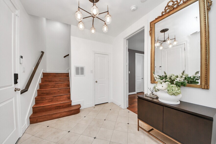 An elegant entry framed in light and texture. - 620 Rutland St