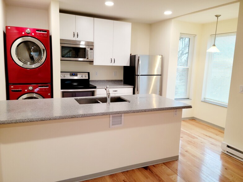 Washer/dryer, microwave, electric stove, and refrigerator. - 6735 Henry Rd