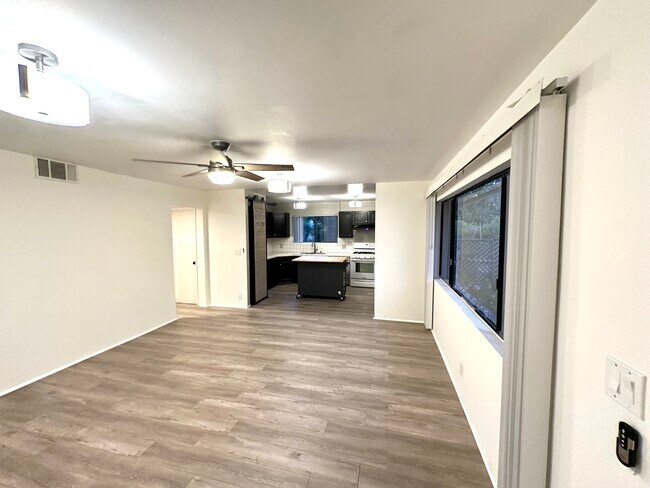 Living room transitioning into kitchen space. - 5303 Alhama Dr
