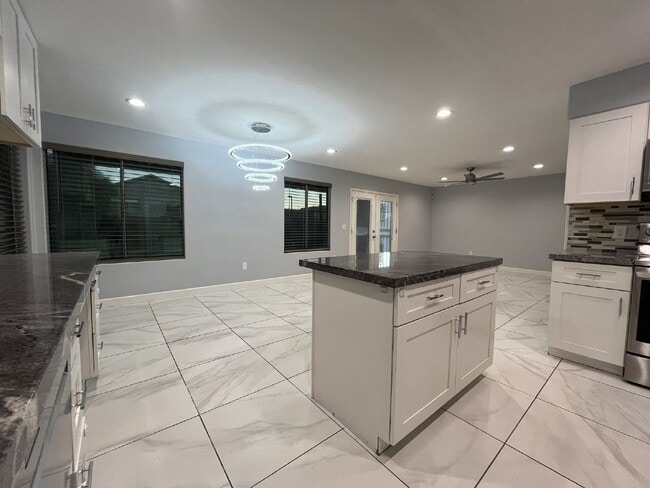 Building Photo - "Charming 4-Bed Oasis with Granite Touch & a Beautiful Pool"