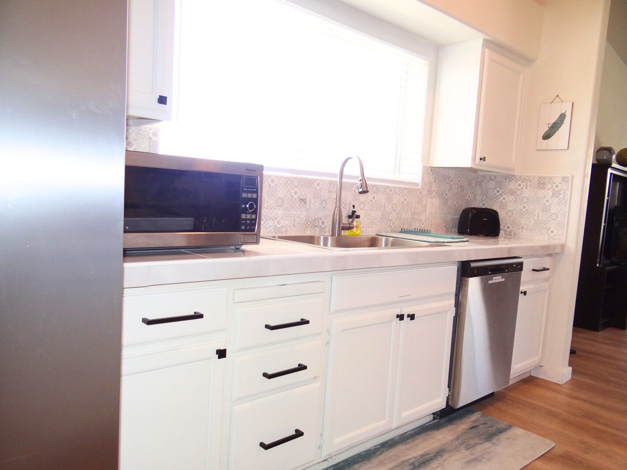 The kitchen has everything you need for your culinary adventures, including all the essentials. - 8941 E 24th Ln