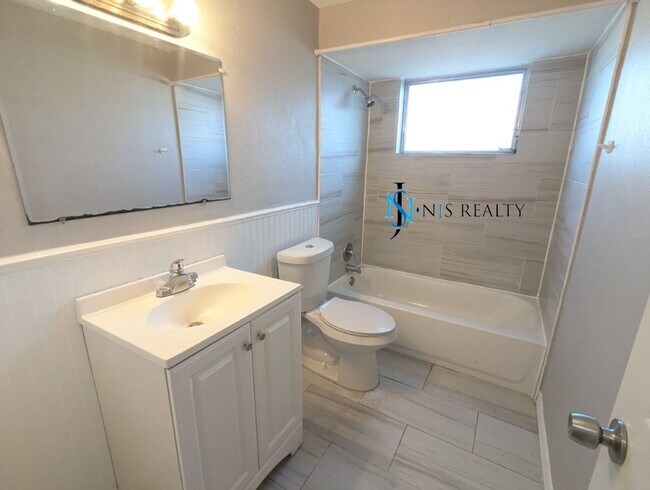 Building Photo - 2/2/1 with  RENOVATED baths & kitchen, fenced yard, NEW lvp flooring and a OVERSIZED lanai!