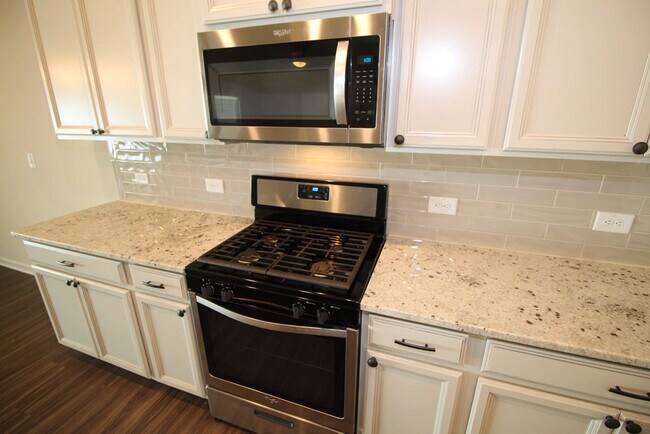 Kitchen features large island, granite counters, tile backsplash, 42 inch cabinets, gas range & upsc - 3406 Dropseed Dr