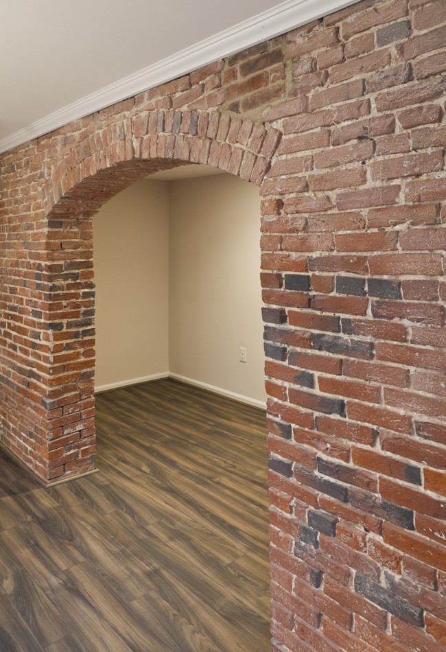 Original exposed brick and brand new plank flooring - Trinity Row