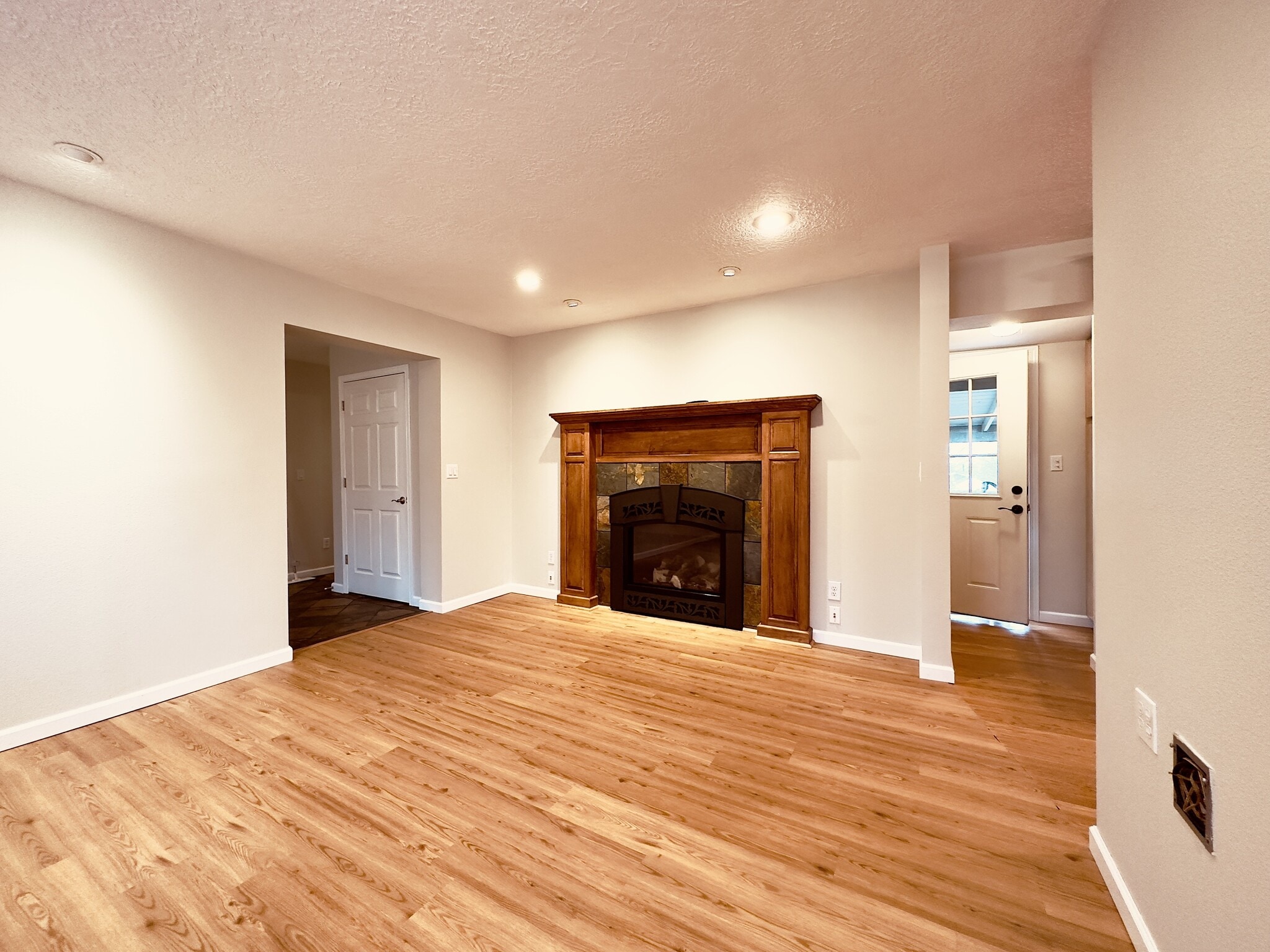 living room. Back door leading to fenced/gated and covered back patio. - 8717 NE Webster St