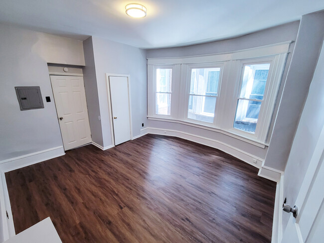 Bedroom with bay window and closet. Image 2. - 1242 S 51st St