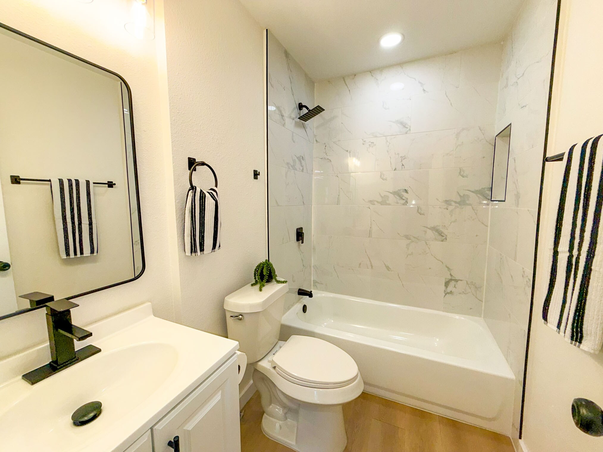 Main bathroom with modern tile. - 308 E Bourn St