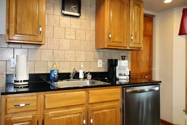 Tiled backsplash for easy cleanup and lots of cabinet storage - 78 Elm St