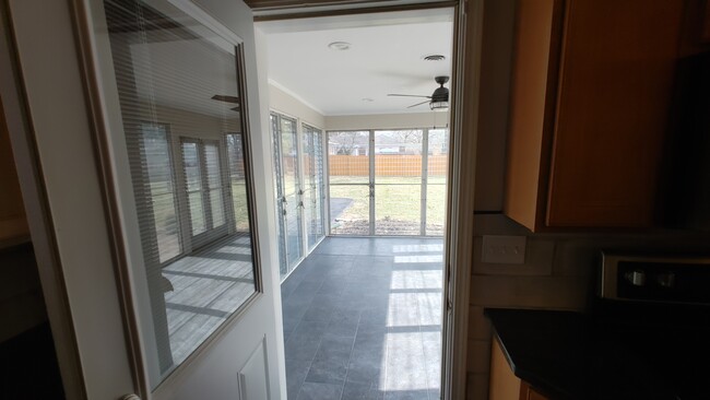 Kitchen door opens to large sunroom area - 6934 Winding Way