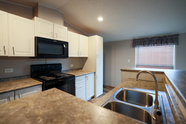 Kitchen including microwave, oven, and sink. - 1225 Orizaba