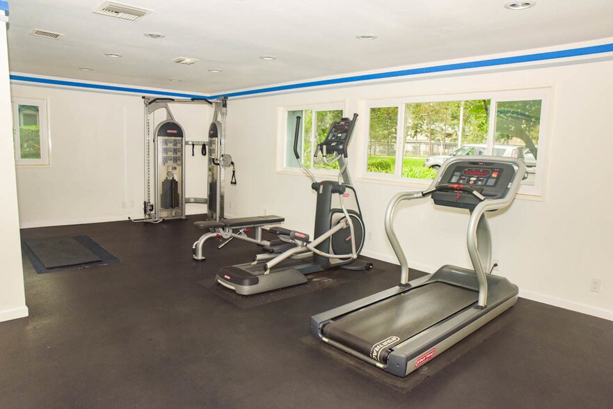 A workout gym is located next to club house. - 6000 Bixby Village Dr