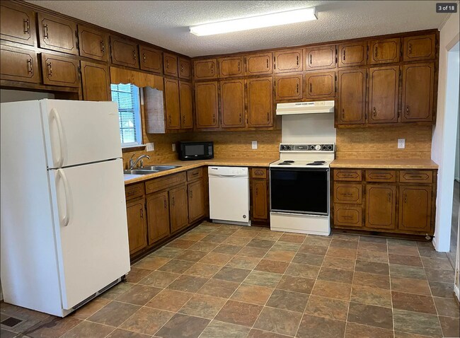 Huge kitchen with refrigerator, freezer, dishwasher, microwave, oven, and plenty of storage - 714 Woodland Dr S