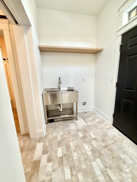 Stainless steel utility sink and spot for spare fridge with ice maker hookup - 24 Ash St N