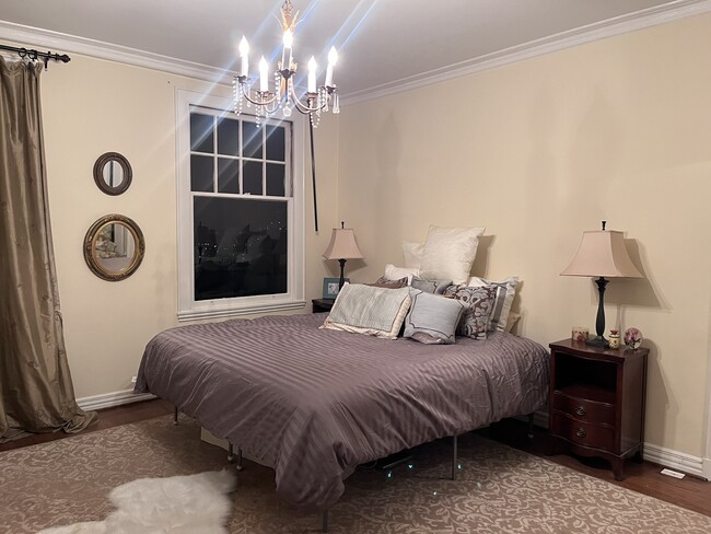 A graceful master bedroom adorned with a magnificent chandelier - 1880 Jackson St