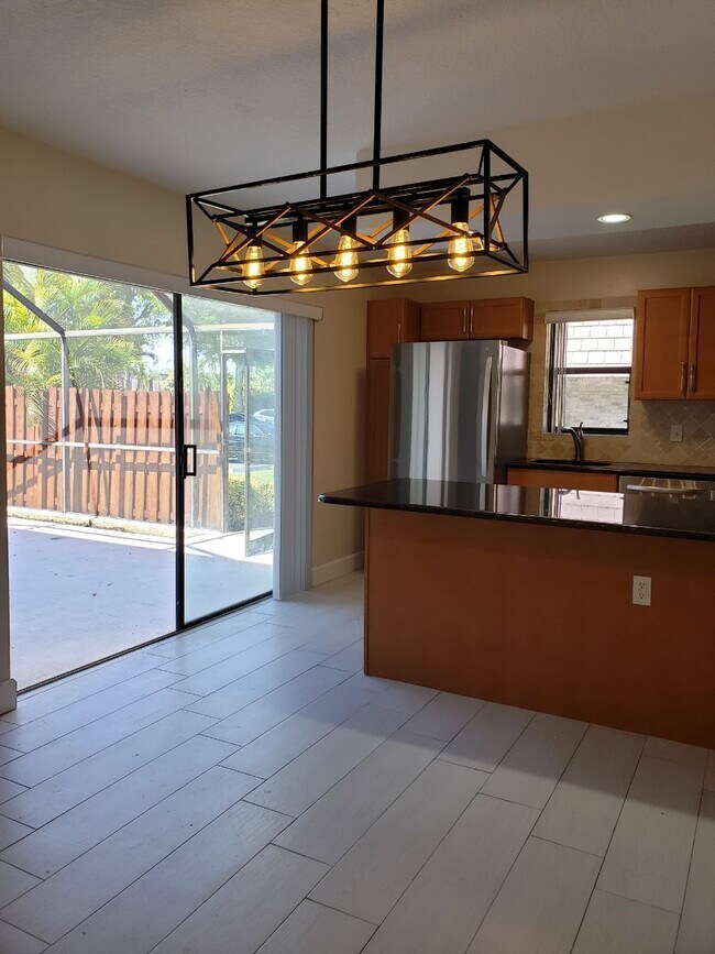 Kitchen open to large patio - 7594 Courtyard Run W