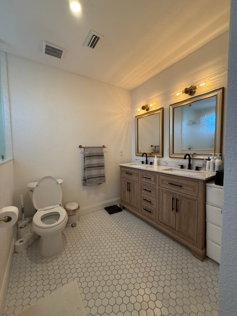 The primary bath is attached to the bedroom and has a double vanity and walk-in shower - 129 36th Ave NE