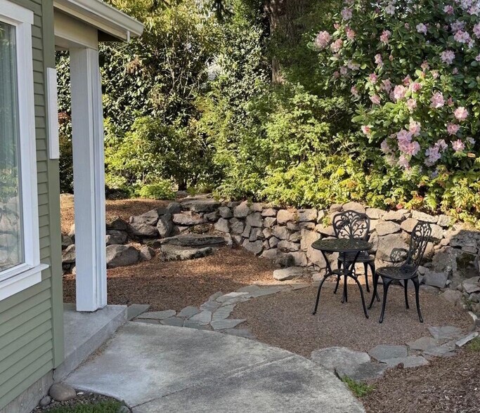 Patio area outside your door surrounded by mature landscaping and large trees. - 9235 SW 7th Ave