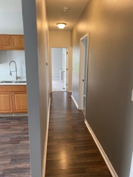 Hall to bedroom on right, bathroom left, 3rd bedroom straight ahead. - 2560 Dupont Avenue South
