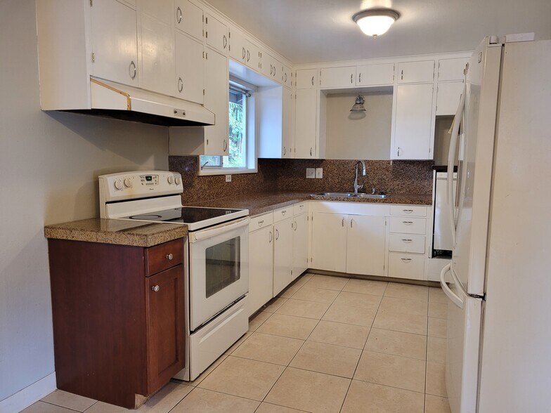 KITCHEN WITH DISPOSAL, RAISED DISHWASHER, RANGE AND FRENCH-DOOR BOTTOM FREEZER REFRIGERATOR - 5955 SW 179th Ave