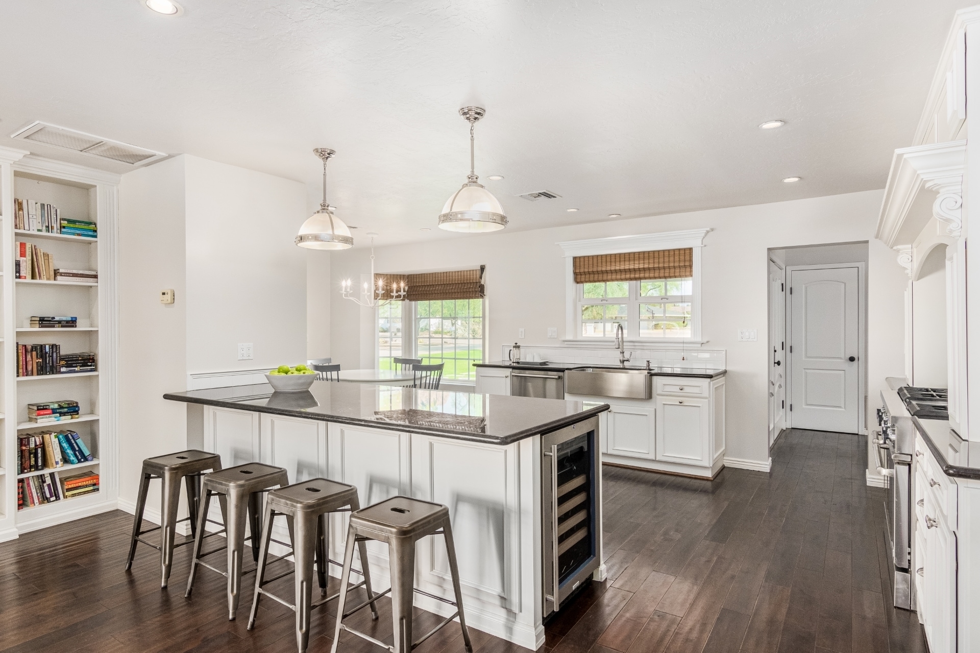 light and bright kitchen looking toward front yard features eat-in island with wine cooler and large farmhouse style stainless steel sink - 5214 N 43RD PL