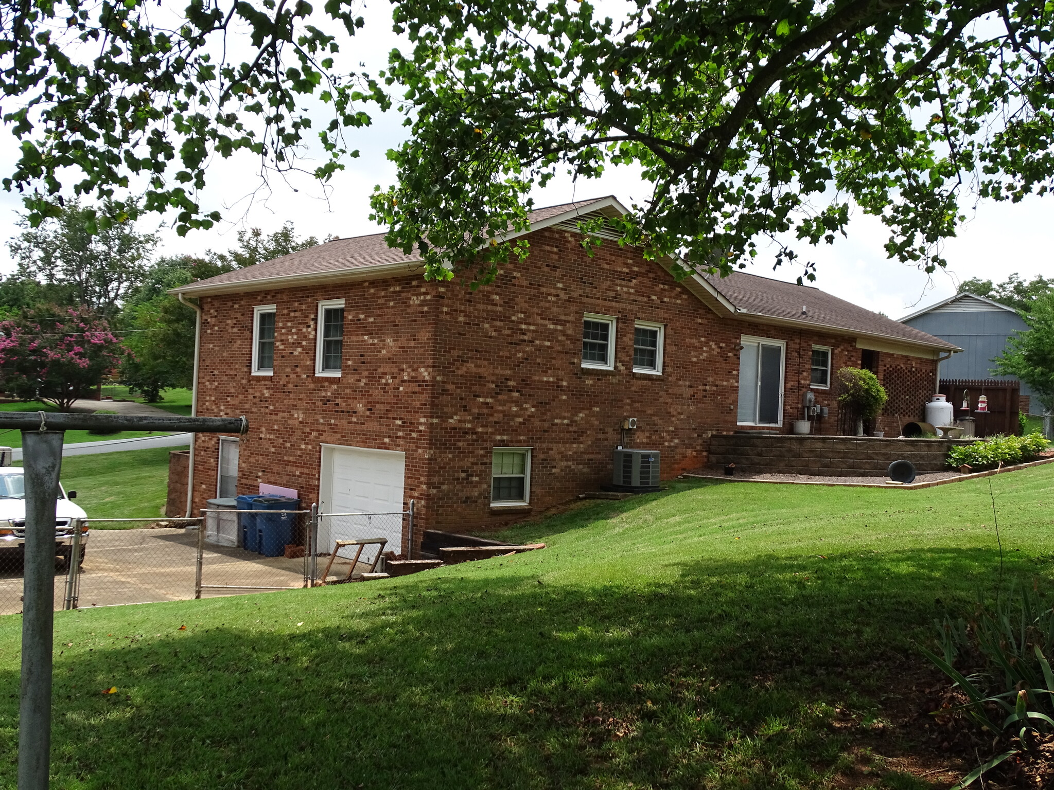 Back of home with bricked patio - 5694 Claridge Dr