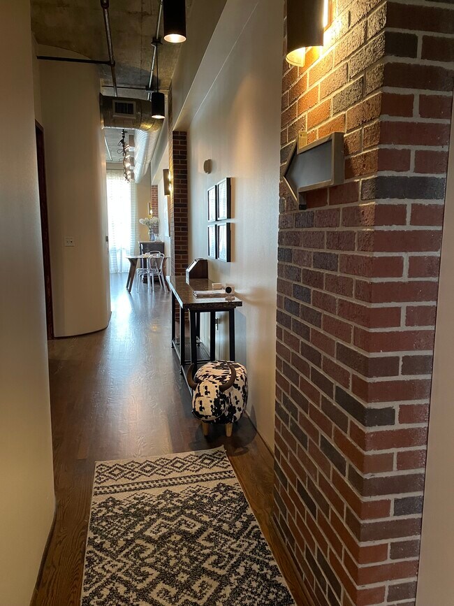 Loft entrance leading to floor-to-ceiling windows and large balcony for downtown views - 505 Bastrop St