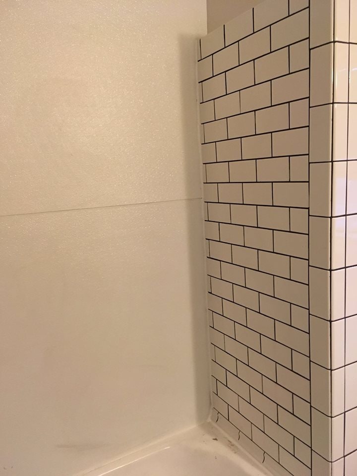 Subway tile on back of tub/shower surround. New shower head and valve, original cast iron tub base - 1545 S 13th St
