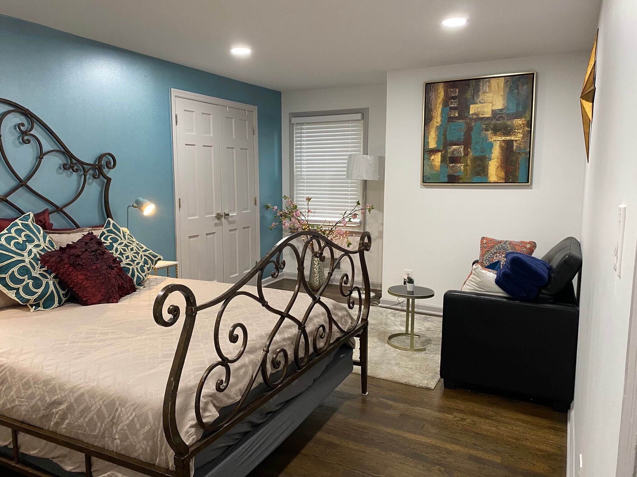 Spacious upstairs bedroom with a queen-sized iron bed — elegant design meets everyday comfort. - 5460 Scofield Rd