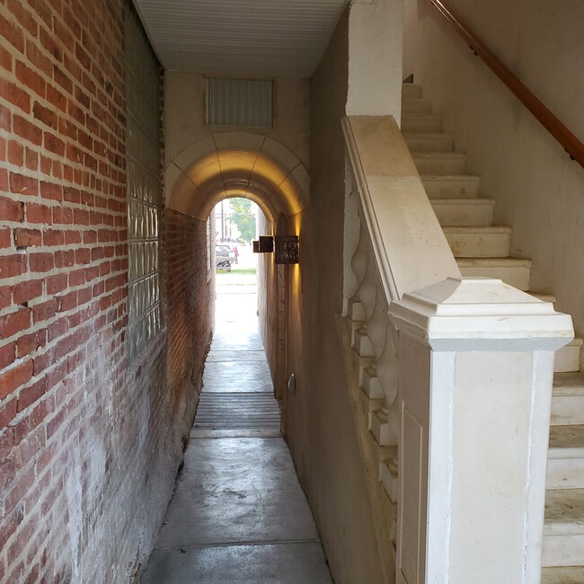 Arched hallway ~ stairs to unit. - 235 E Market St